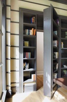 a blurry image of a person sitting in front of a book shelf