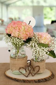 two vases filled with flowers on top of a table