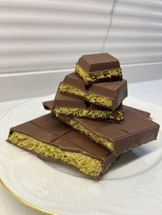 a stack of chocolate bars sitting on top of a white plate