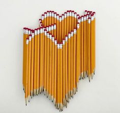 several pencils arranged in the shape of a heart