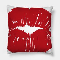 a red and white pillow with the shape of a kiss on it's lips