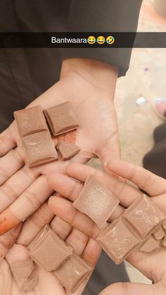 several hands holding small pieces of chocolate