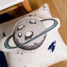 a pillow with an image of saturn on it