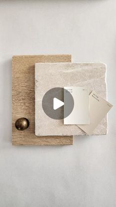 a piece of paper sitting on top of a wooden cutting board next to a metal object