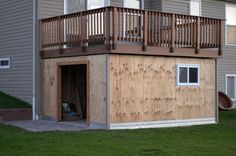 a house that is being built with wood siding and balconies on the roof