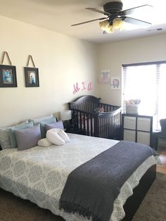 a baby's room with a crib, dresser and bed