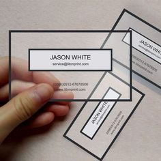 a person is holding some business cards in their hand