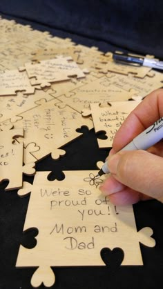 a person is writing on some puzzle pieces