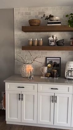 a kitchen with white cabinets and open shelves