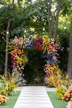 an outdoor ceremony with colorful flowers and greenery