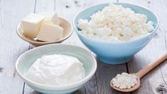 cottage cheese in a blue bowl next to a jug of milk