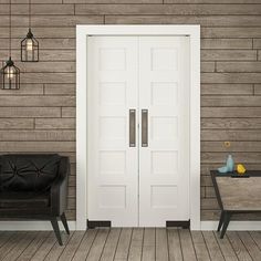 a black chair sitting in front of a white door on a wooden floor next to a wall