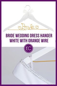 the bride's dress hanger is white with orange wire and purple lettering on it