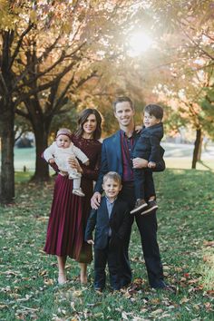 a family posing for a photo in the park