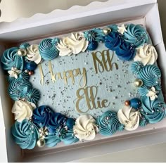 a blue and white birthday cake in a box