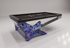 a billiard table with blue and purple designs on it, in front of a white background