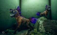 two statues of horses are in front of a mirror on the wall next to rocks and plants