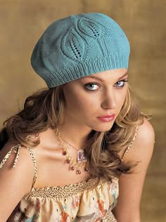 a woman wearing a blue knitted hat