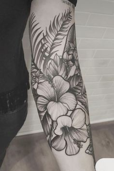 a black and white flower tattoo on the arm