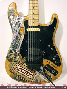 an electric guitar with stickers all over it