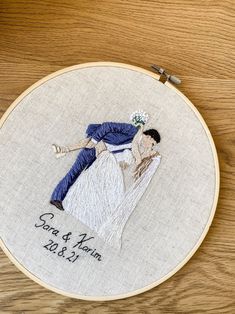 a hand embroidered photo of a bride and groom