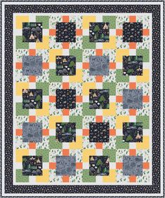 a quilt with squares and trees on it