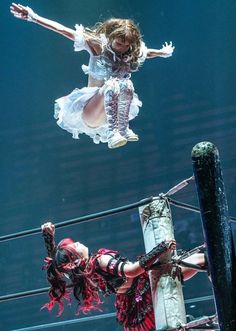 two circus performers performing on the ropes