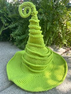 a crocheted green hat sitting on the ground