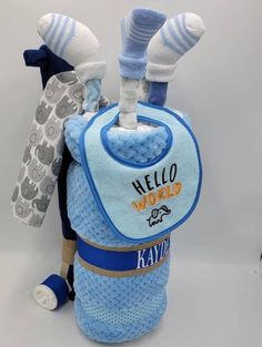 a blue baby bib with white socks on it and a hello world backpack attached to it