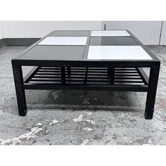 a black and white coffee table with glass top