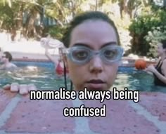 a woman wearing goggles standing in front of a swimming pool with the caption normalise always being confused