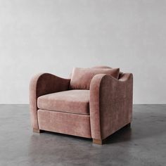 a pink chair sitting on top of a cement floor next to a wall in an empty room