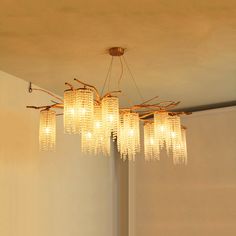 a chandelier hanging from the ceiling in a room with white walls and flooring