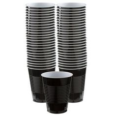 black and white cups stacked on top of each other in front of a white background