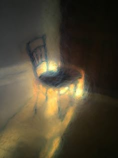 a chair sitting on top of a floor next to a wall with light coming through it