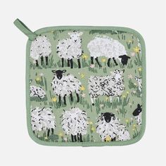 a green pot holder with sheep on it