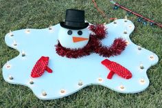 a snowman decoration on top of a white board