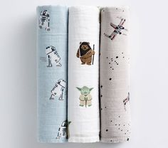 three baby swaddles with star wars designs on them are lined up next to each other