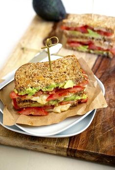 a sandwich is sitting on a plate next to a knife