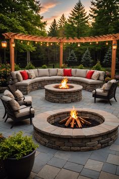 an outdoor fire pit surrounded by seating and lights