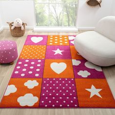 a brightly colored area rug with hearts, stars and clouds on it in a child's room