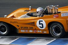 an orange race car with the number five on it