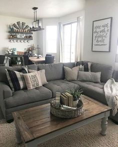 a living room filled with lots of furniture and pillows on top of a coffee table