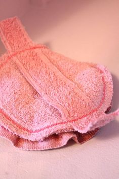 a pink towel sitting on top of a white counter