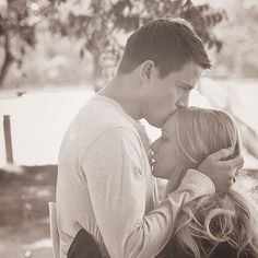 a young man and woman kissing each other