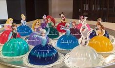 there are many disney princess cake toppers on this plate, all in different colors