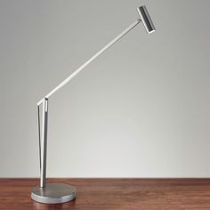 a desk lamp sitting on top of a wooden table