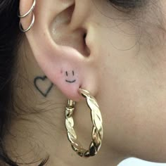 an ear with a smiley face drawn on it's side, and the word love is