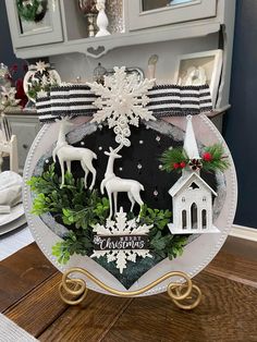 a white plate topped with christmas decorations on top of a wooden table