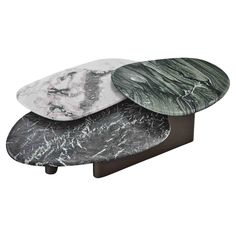 three marble tables stacked on top of each other with different shapes and sizes in the middle